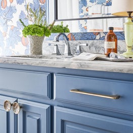 Guest Suite Bath Featuring Blue Cabinetry & Wallpaper