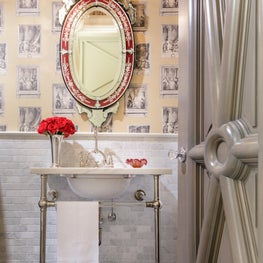 Custom door setting tone of grandeur for this powder room