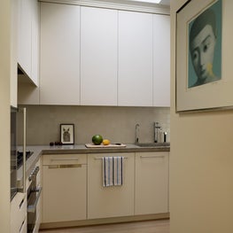 White kitchen with skylight and sleek cabinetry