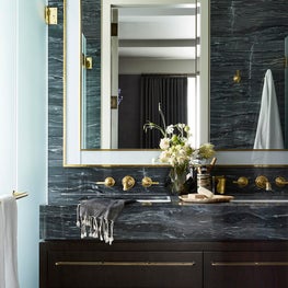 Modern master bathroom with custom marble and brass plumbing fixtures