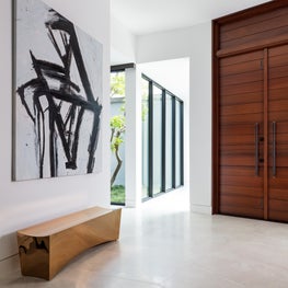 Entryway with dramatic art and custom contemporary bench