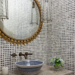 Texture & pattern with classic fixtures adds sophistication to the powder room. 