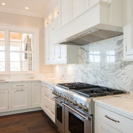 Kitchen with White Cabinets and Full height Marble Slab Backsplash