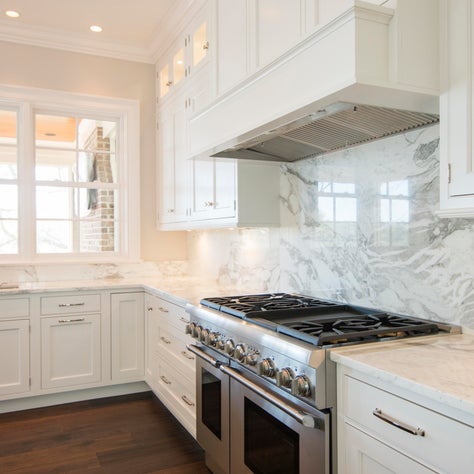 Kitchen with White Cabinets and Full height Marble Slab Backsplash