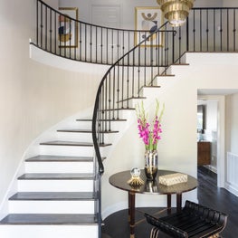 Foyer with metal tiered chandelier and custom entry table/seating