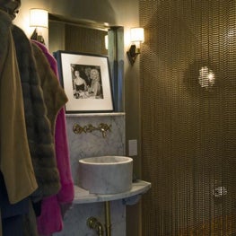 Unexpected combination of a powder room and coat closet