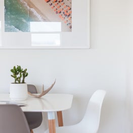 Bohemian Beach House - Breakfast Table. Framed Photography. Eames Chairs. 