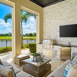 Expansive Decadent Waterfront, outdoor living room, outdoor kitchen, coastal view, poolside, neutral outdoor kitchen, columns