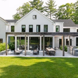 Farmhouse modern renovation with cedar trellis