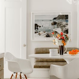 Madison Avenue Kitchen with Upholstered Banquette, Eames Fiberglass Shell Armchairs and Alden Baker Ceramics