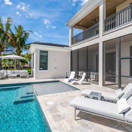 SLEEK CONTEMPORARY METALLIC RESIDENCE pools side patio, inground pool, balcony pool, white lounge chairs, coastal living