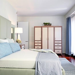 West Village Triplex Master Bedroom with custom cabinetry, blue drapery
