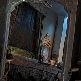 beverly hills residence master bedroom as seen through vintage mirror