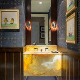 Tailored Powder Room in a Coastal High-Rise with Backlit Onyx Vanity