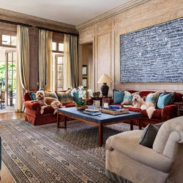 This family room exudes casual sophistication and showcases oversized modern art.