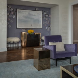 NYC Apartment Entryway, patterned wallpaper, upholstered ottomans, purple 