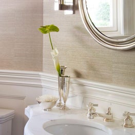 Grasscloth wallpaper is a subtle nod to the home's coastal location.