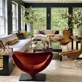 This historic sunroom designed by famed Atlanta architect, Philip Trammell Shutze sets a classical backdrop for this modern space filled with iconic Midcentury pieces covered in Jim Thompson fabrics.