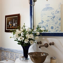This powder room is highlighted with delicate shades of floral blue. 