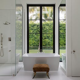 Simplicity in a modern bath; with garden views through steel doors