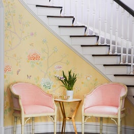 Curved stairway in a large entry hall in a historic 1915 Hal Thompson house.