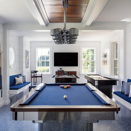 A modern game room in blues and whites with classical nautical details