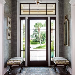Upon entry there is a blue patterned area rug by Lee Jofa.