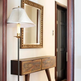Entry hall featuring a custom hand painted console table & Carlos Bugatti mirror