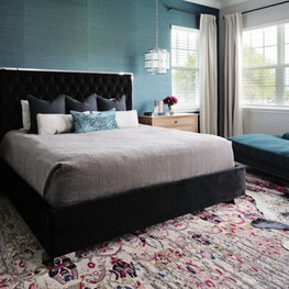 Glamorous teal textured walls with symmetrical lighting & velvet chaise lounge.