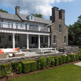 Outdoor living with contemporaneity woven patio furniture, interesting railing.