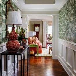 In this hallway the dark wood floors and green patterned wallpaper is a tribute to Autumn.