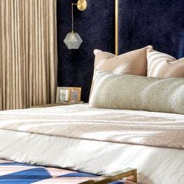 Portfolio: Jewel-toned master bedroom vignette with blue headboard and neutral accents