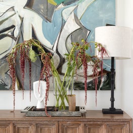 Portfolio: A Michael Kennaugh painting over a carved console in modern dining room