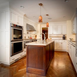 Solid cherry, herringbone floor,dark stained island:painted off white perimeter.