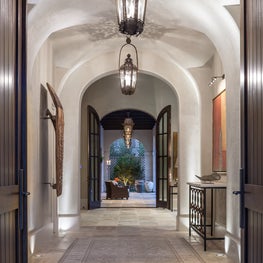 Dramatic entry with a series of groin vaults & antique lanterns; Houston, TX