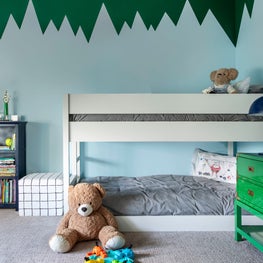 Portfolio: A kids bedroom with a blue wall and a bunk bed