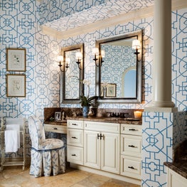  A patterned wallpaper and fabrics are in the same tonality as the master suite.