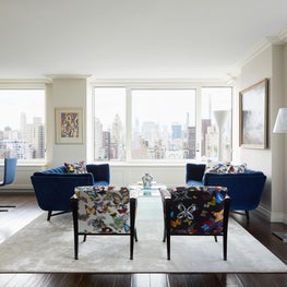 Bright white living room with butterfly print chairs