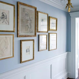 A hallway sports a classic combination of brass and blue. 