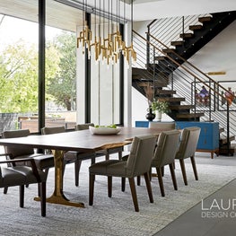 With a live-edge top and brass base, this custom dining table serves as the defining element of the dining room.