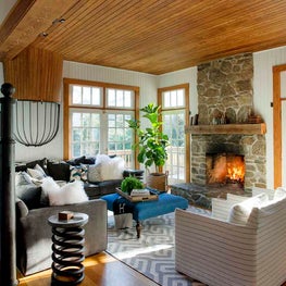 Barn Living Room with Stone Fireplace and Wood Paneled Ceiling