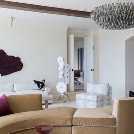 Portfolio: An art piece by Donald Martiny hangs over a serpentine sofa and near a vintage Murano chandelier in Pebble Beach, CA.