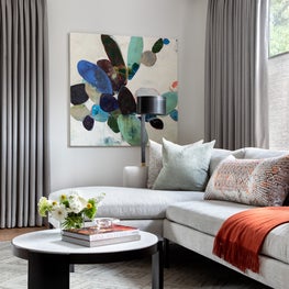 Portfolio: Master sitting room with rusty red throw and sandy toned sofa