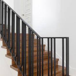 Stairwell with Custom Railing, Door Detail, and new wood flooring