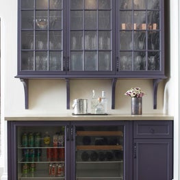 The seeded glass door panels add texture and character to this built in bar