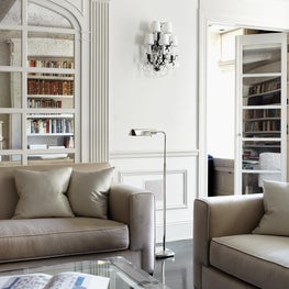 Luxurious Upper East Side living room with mirrored wall and wainscoted wall