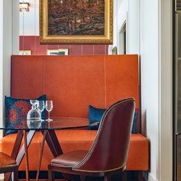 Boston apartment, dining room with custom banquette and mirrored wall 