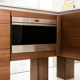 Portfolio: Dark wood cabinets and a modern appliance in a Poggenpohl kitchen