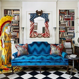Vintage Americana delights in this antique dealer's secluded city dwelling. Graphic pops range from the signature checkerboard floor to the dazzling Jim Thompson fabrics. Built-in bookcases hold a research library in this historic 1920's carriage house.