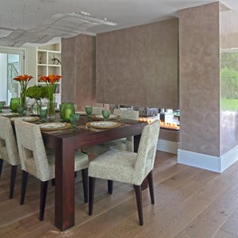 Open plan dining room with double aspect fireplace 